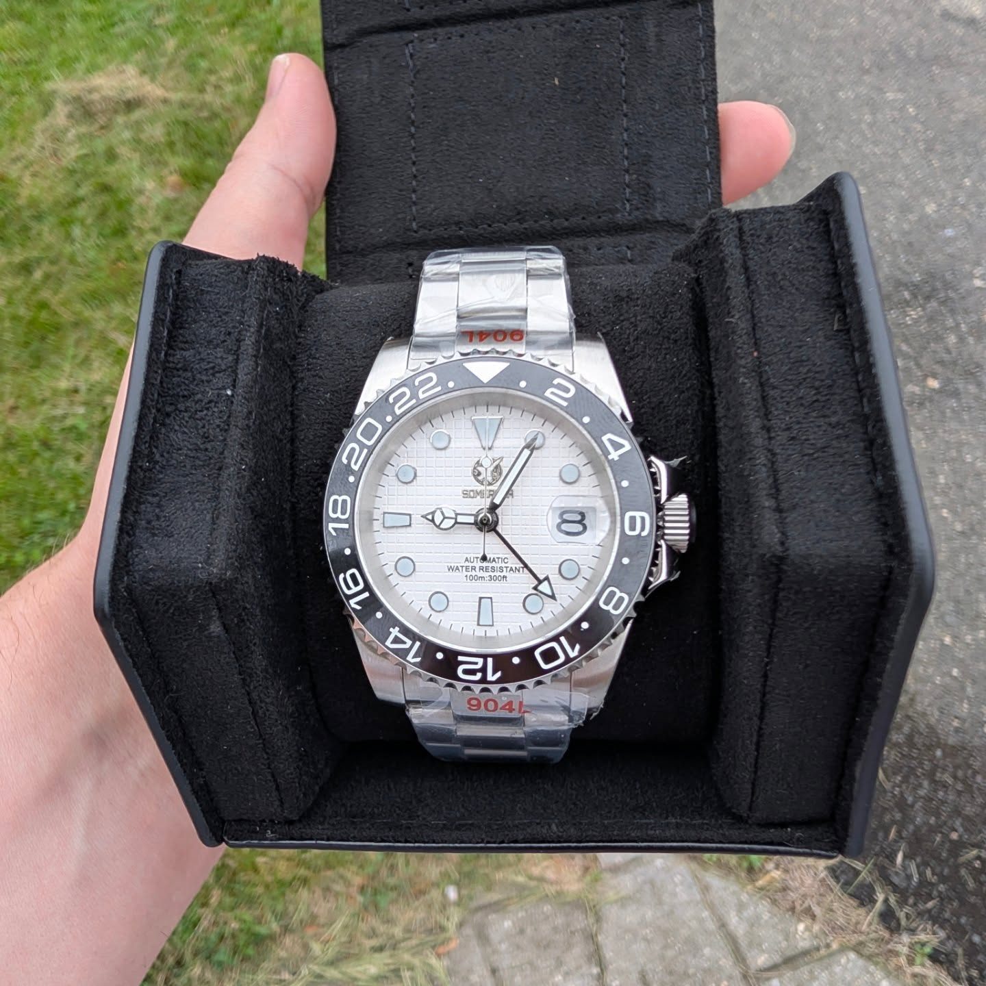 White dial GMT with all black bezel in travel case